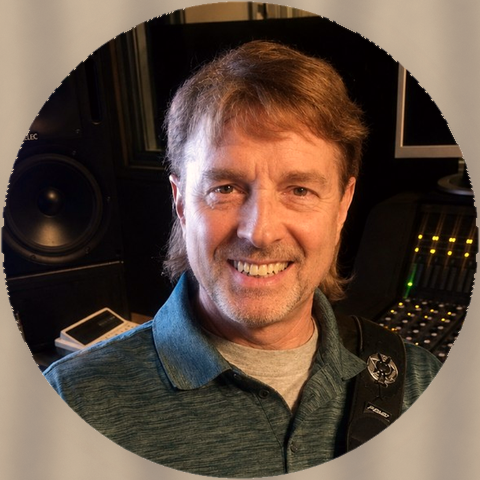 Chuck Foley with his guitar in a recording studio
